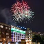 Outdoor fireworks show over building